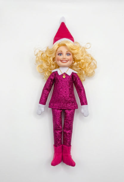 Dolly Parton Christmas elf doll featuring iconic big blonde hair and a glamorous sparkly pink outfit.