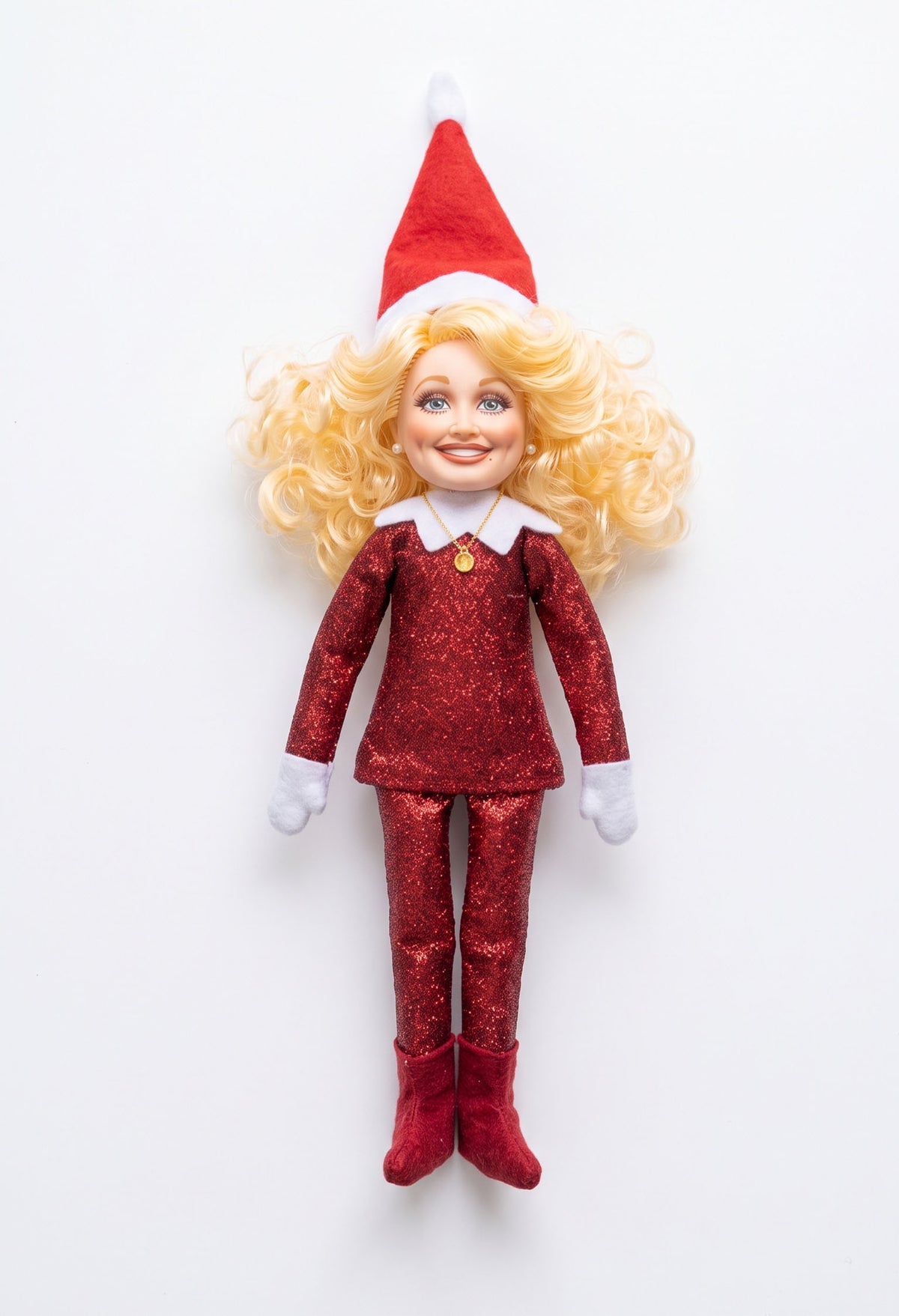 Red glitter Dolly Parton inspired Christmas elf doll on a clean white background.